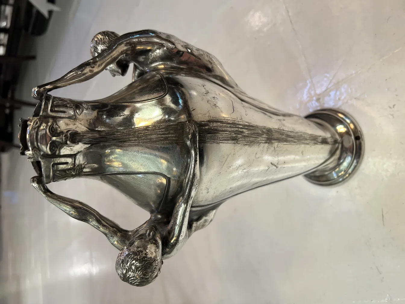 antique vase featuring sculptural details and figures