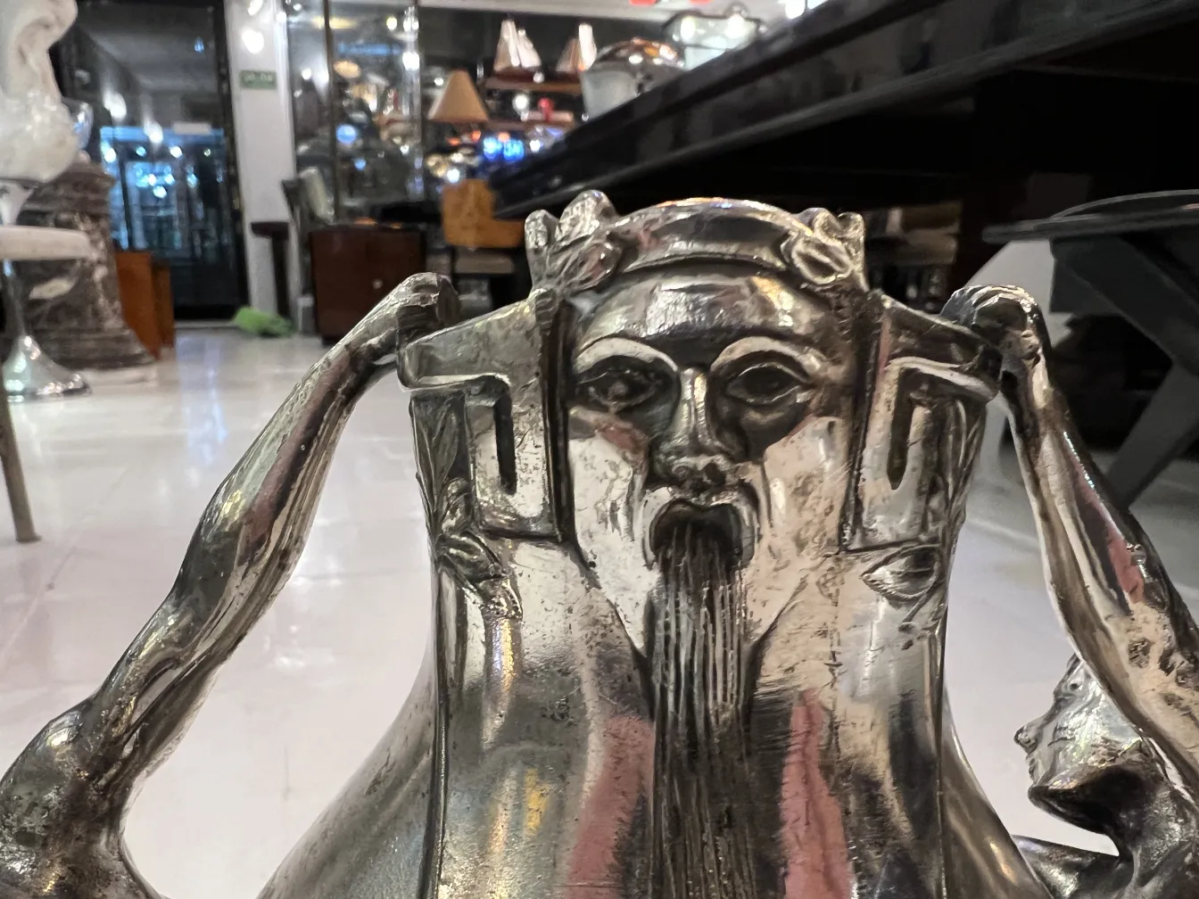 antique vase featuring human figure, ornately detailed