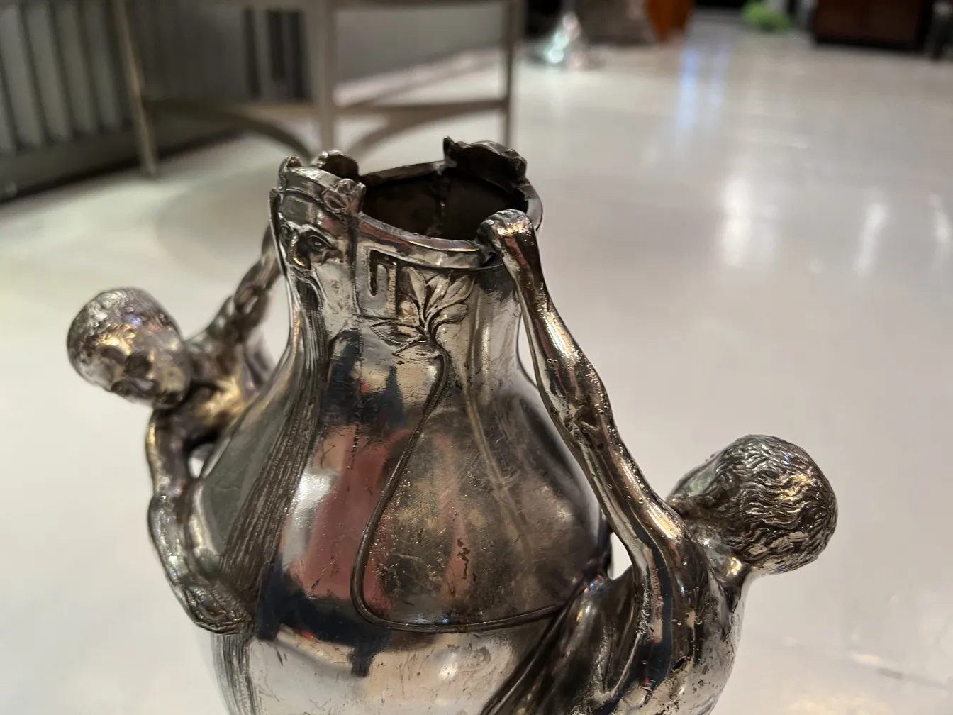 antique vase with two human figures holding it