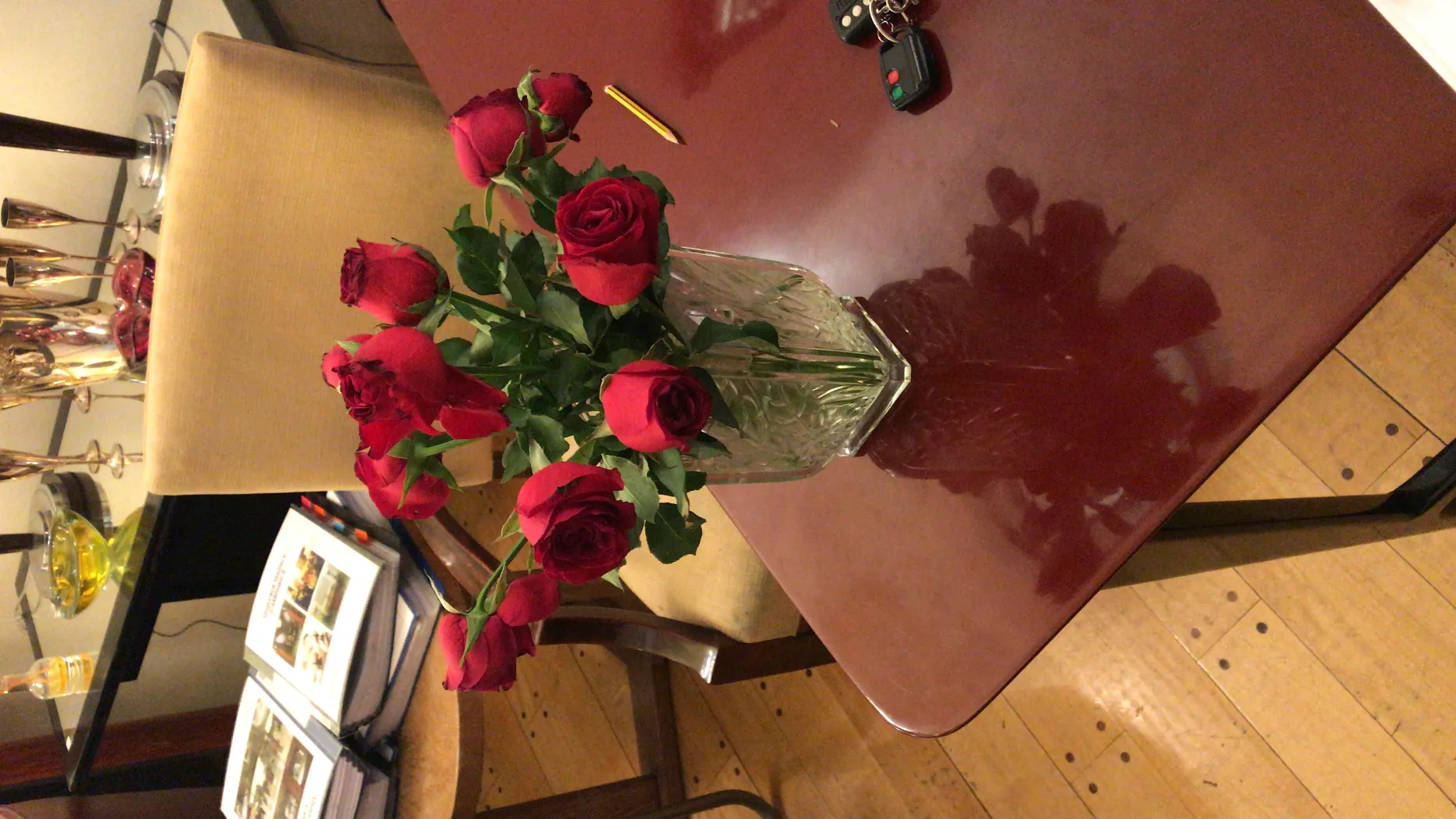 antique vase with red roses on a table