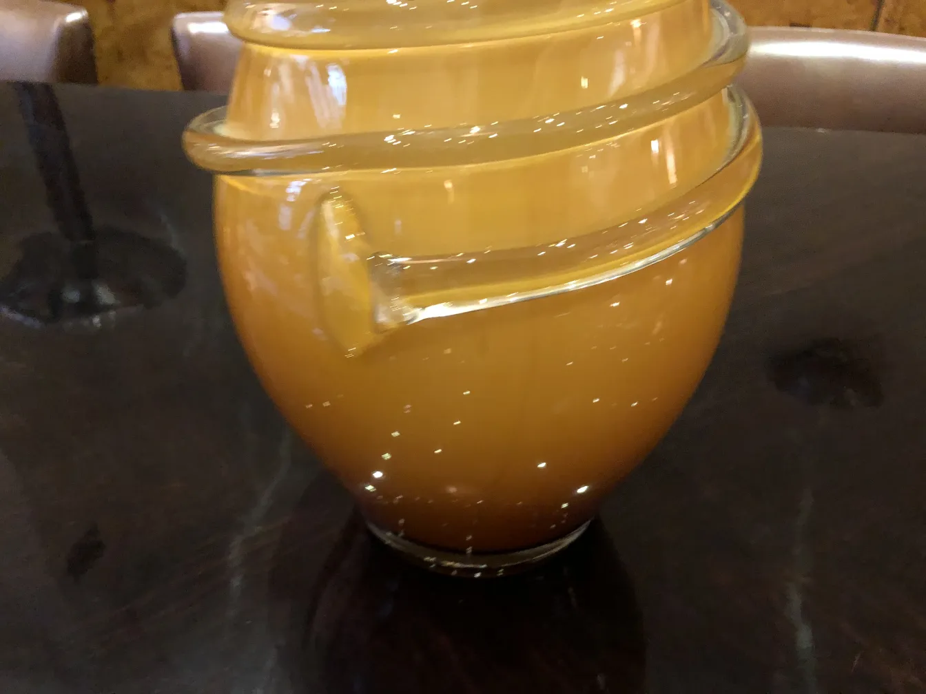 antique vase on a dark table, featuring a curved design