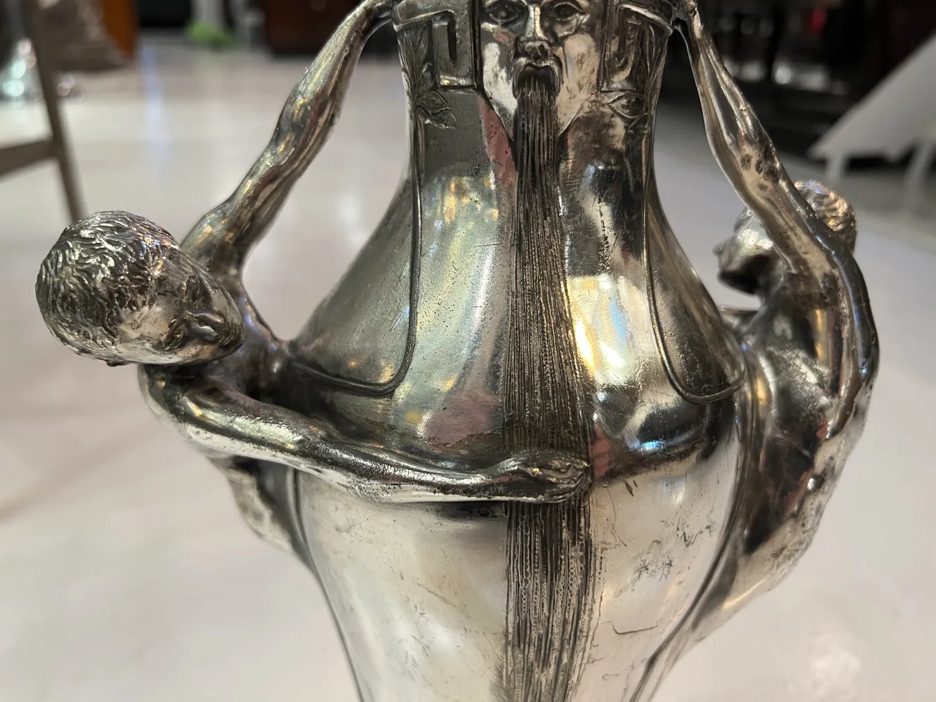 Antique vase showcasing artistic figures and unique details, elegant ambiance.