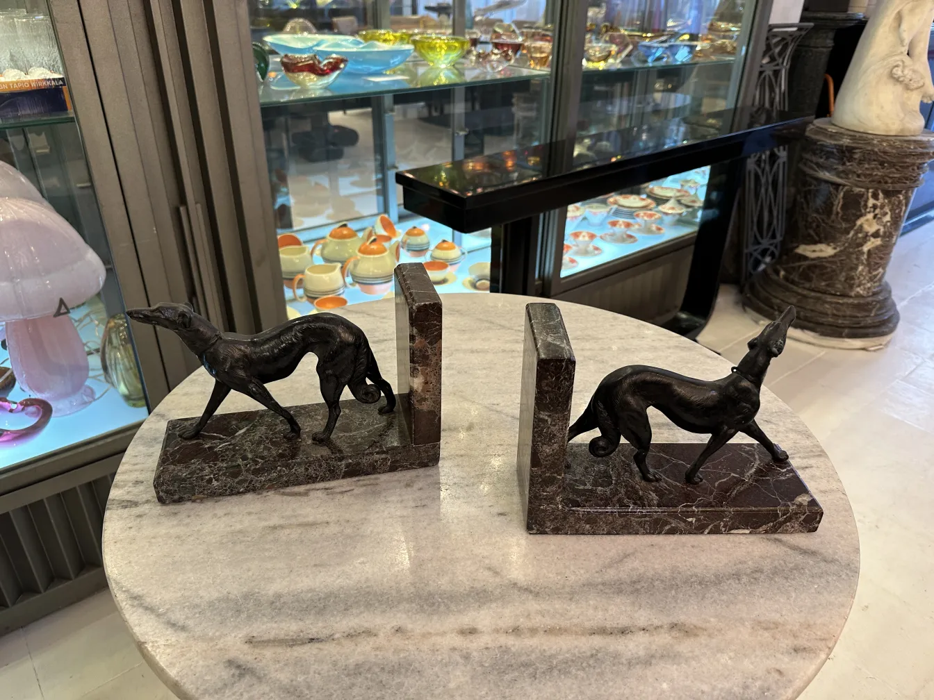 Antique bookends shaped like dogs in an elegant setting.