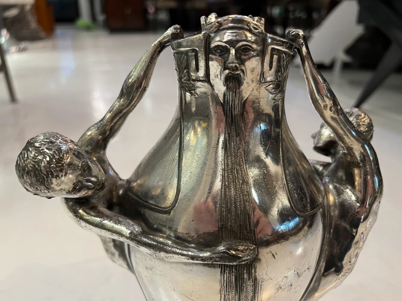 antique vase decorated with relief human figures