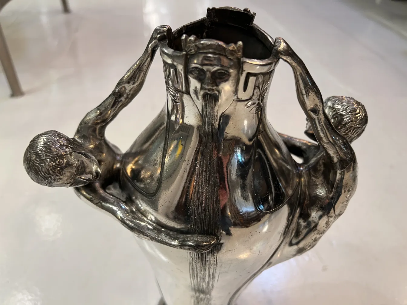 Antique vase with carved and decorative figures on the sides, white background