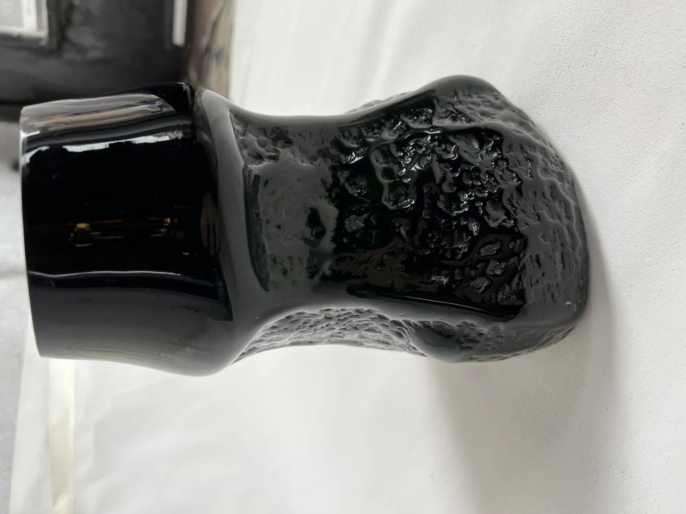 antique black vase with unique, smooth texture