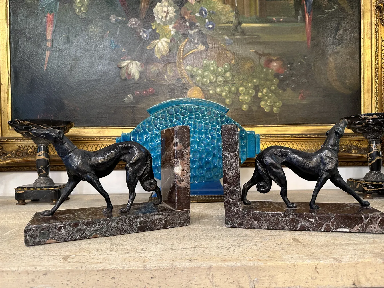 Antique bookends shaped like dogs in a cozy setting