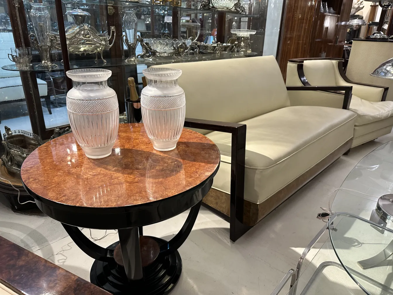 2 antique vases on a table beside a couch
