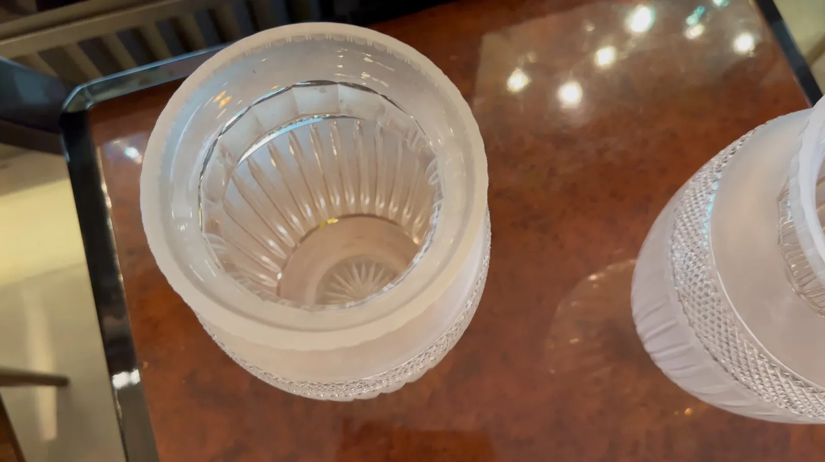 2 antique vases with translucent design on a table