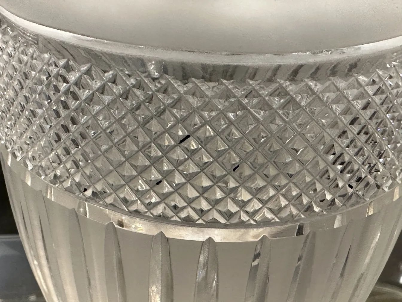 two antique vases made of cut glass with decorative patterns