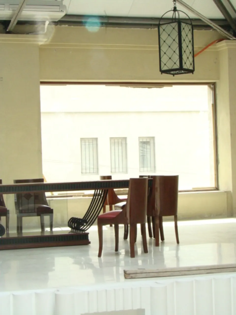 Antique art deco dining table for 12 people in a bright and spacious setting.