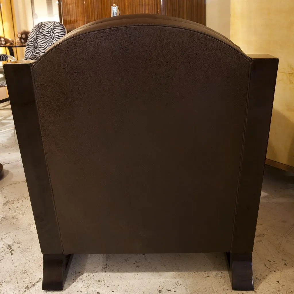 Rear view of two antique art deco armchairs in an elegant setting.