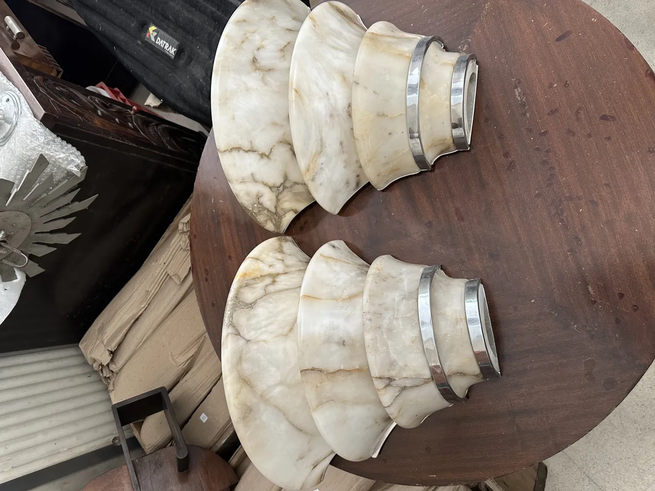 Antique sconces with curved design, ideal for decor.