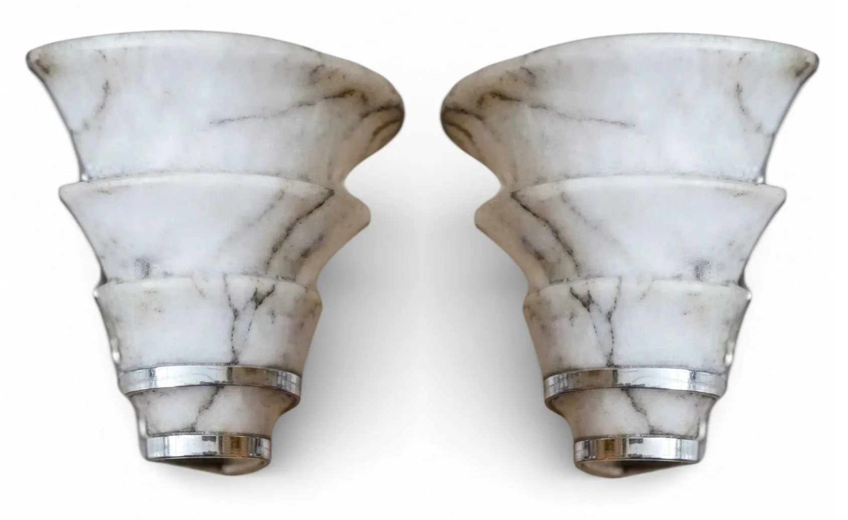antique pair of sconces with curved shape and soft details in a classic setting