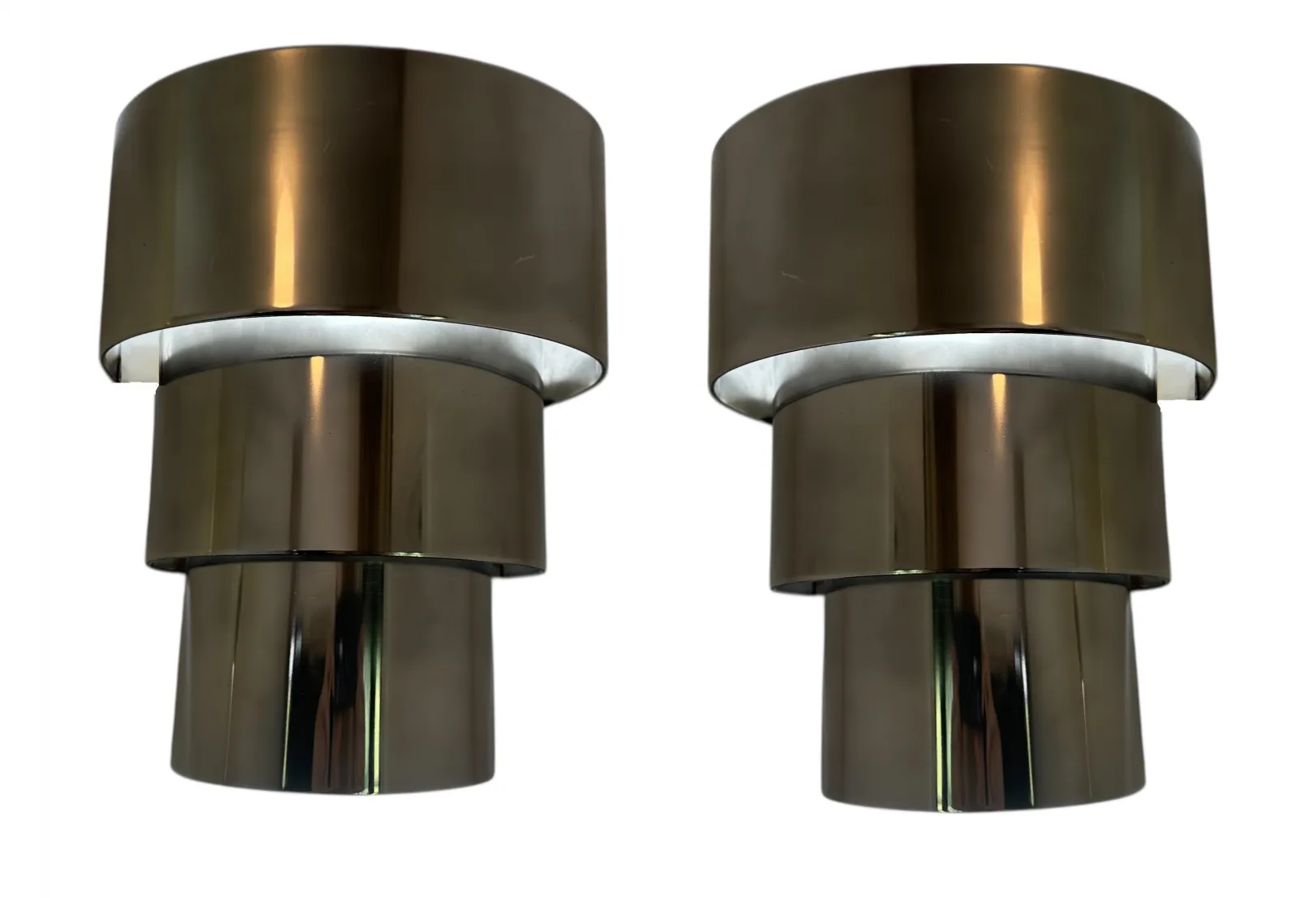 Antique pair of sconces with elegant design and shiny finish, softly illuminating a cozy environment.