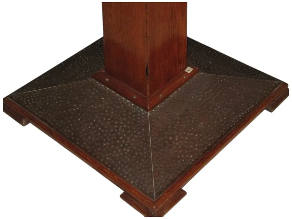 Base of antique dining table with distinctive details in a cozy setting, suitable for 4 people.