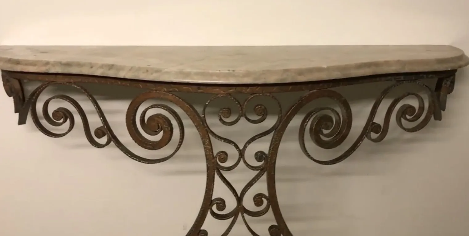 antique console with decorative iron details and elegant shape