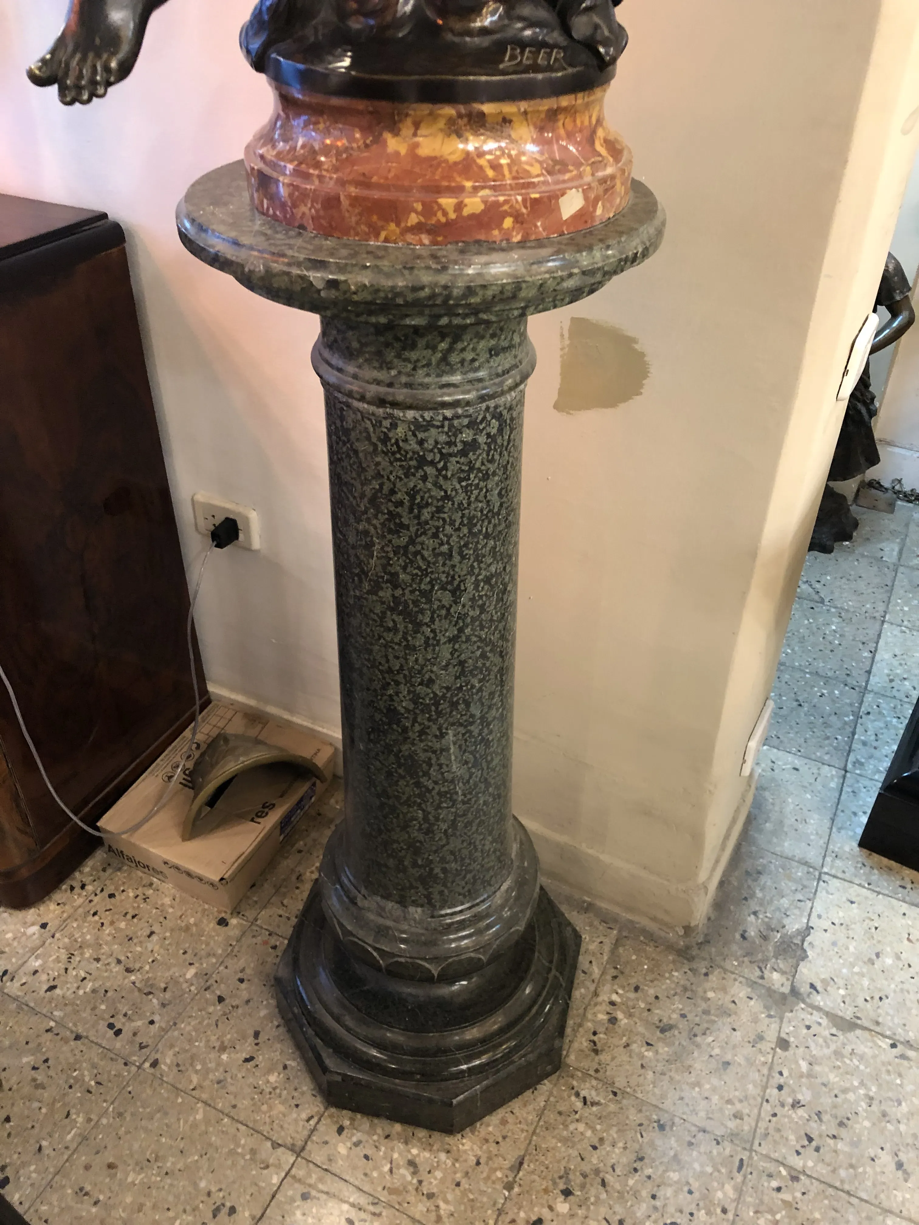 Antique column with decorative base and carved details