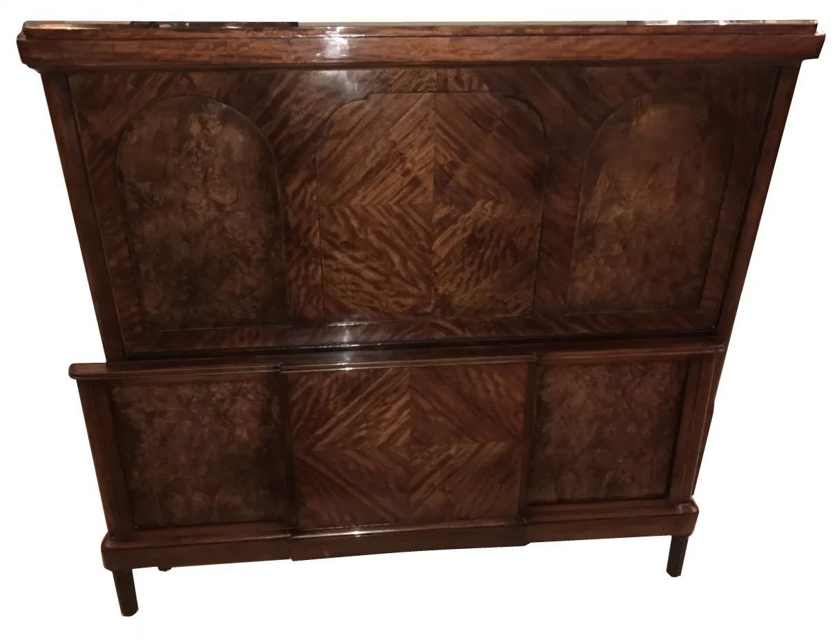 Antique bed in Art Deco style with dark tones