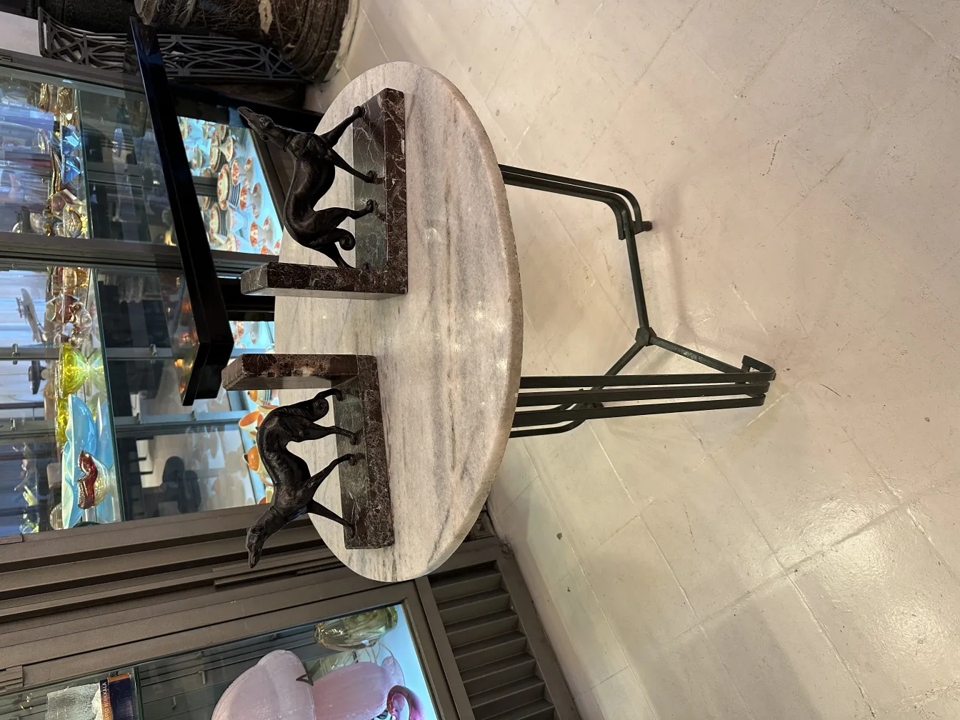 Antique bookends featuring dog figures, set in a bright environment.