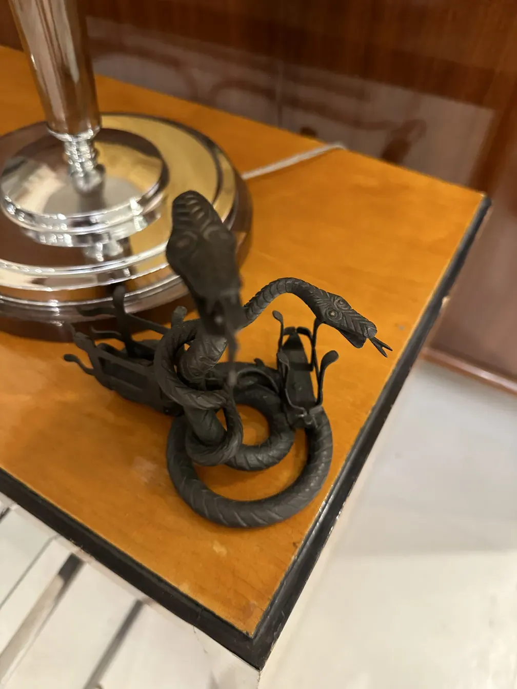 Antique card tray with decorative snakes and elegant design.