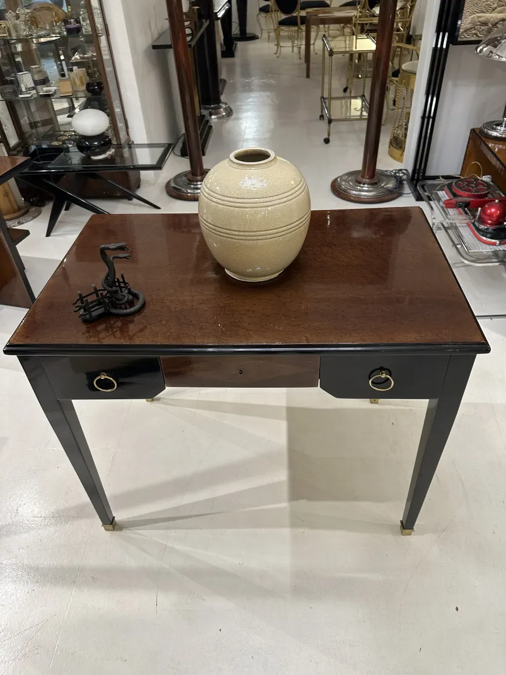 Antique card tray with decorations and a ceramic jar.