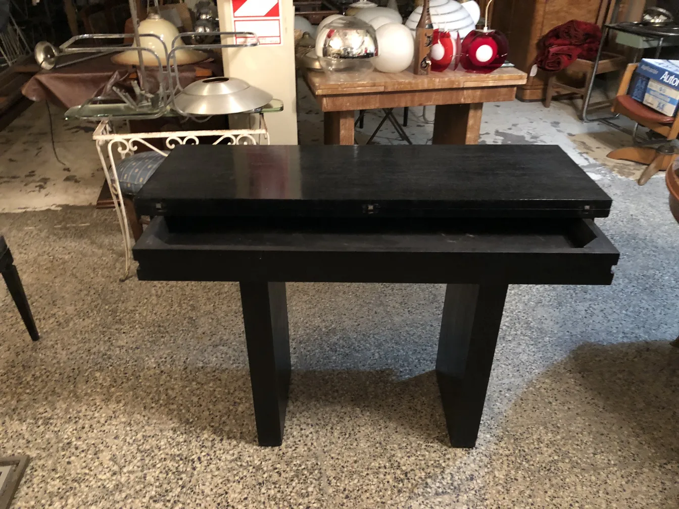 antique black console with a drawer in a cozy setting