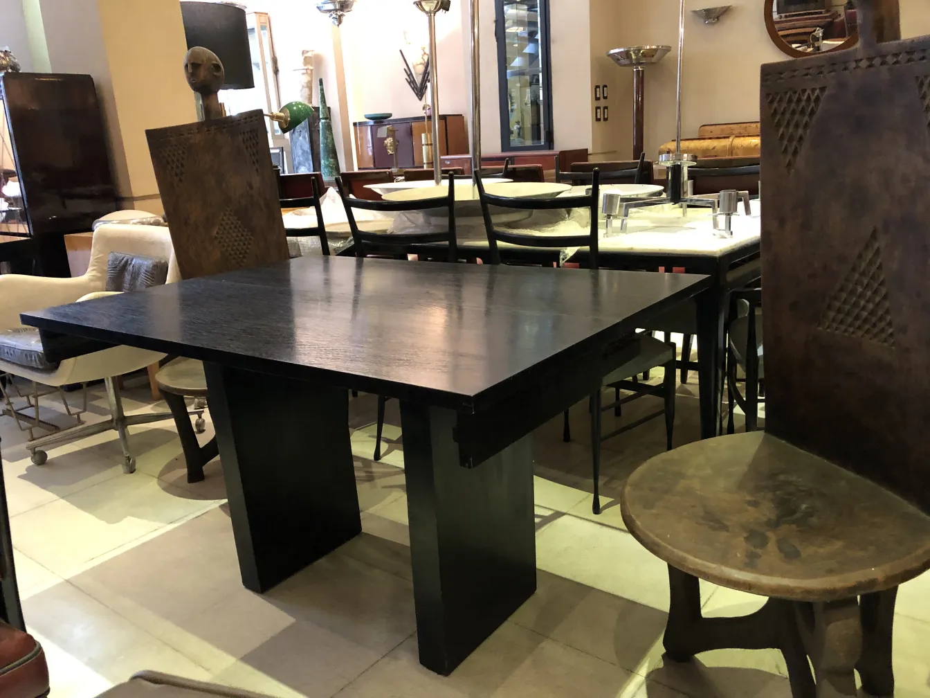 Antique console in a space with varied furniture