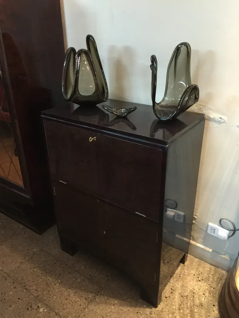 Antique bar cabinet with elegant decor and glass vases