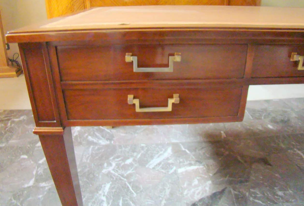 antique desk by Jean Michel Frank with gold handles.