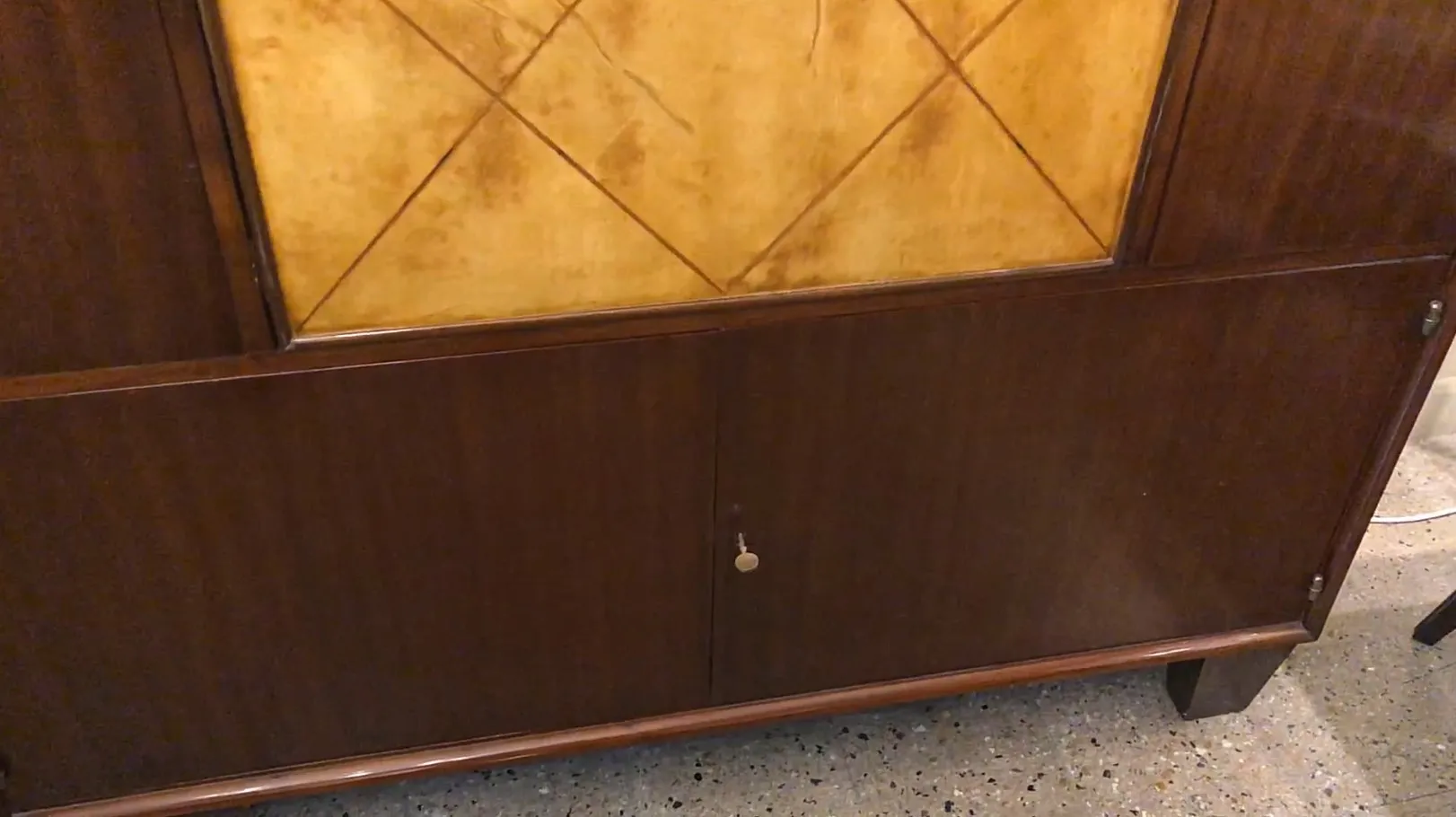 antique bookcase with art deco design, featuring doors and a key