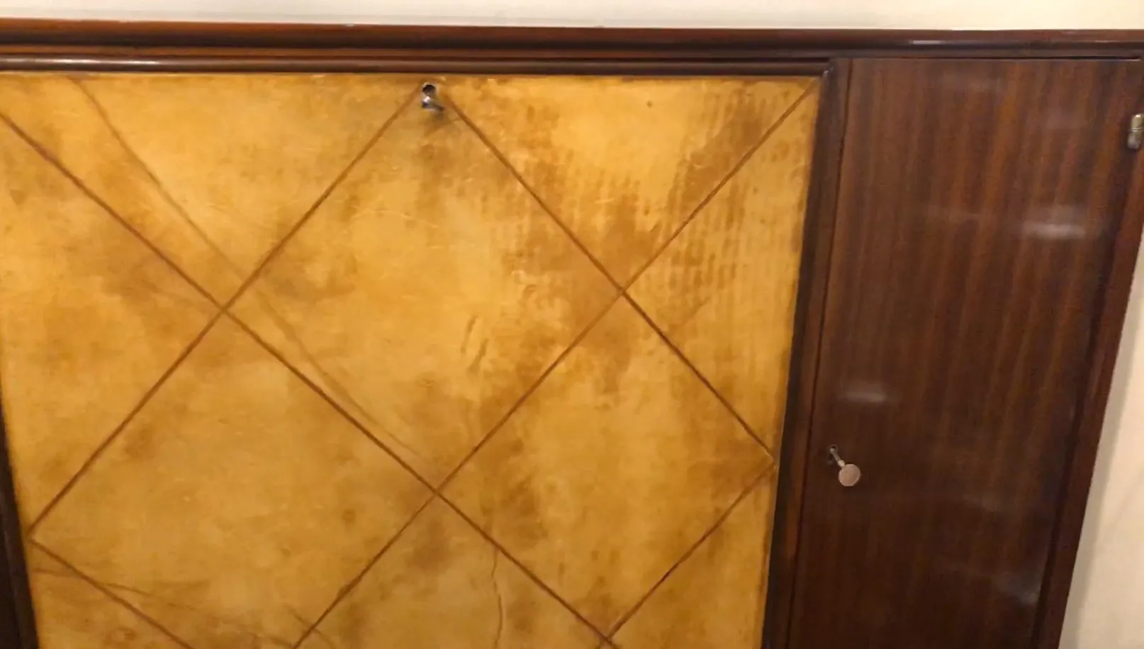 antique bookcase with yellow finish and golden door