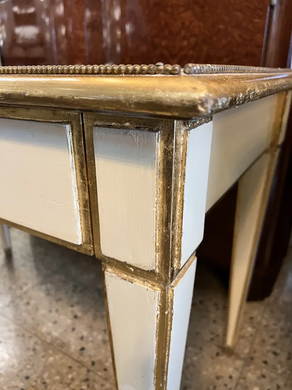 Details of an antique console from Alvear Palace, featuring gold accents and a classic design.