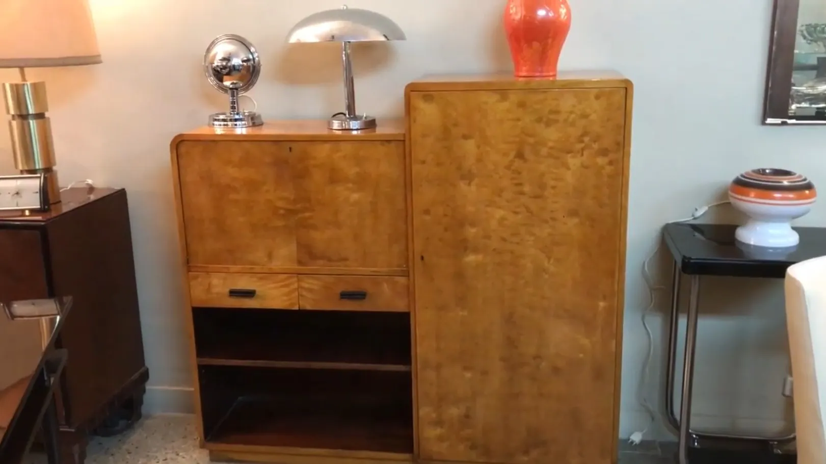 Antique wooden desk with storage compartments in a cozy setting.