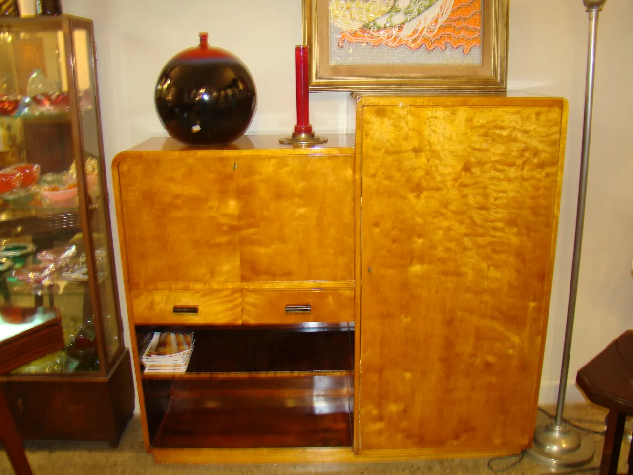 Antique wooden desk with shelf, adorned with a lamp.