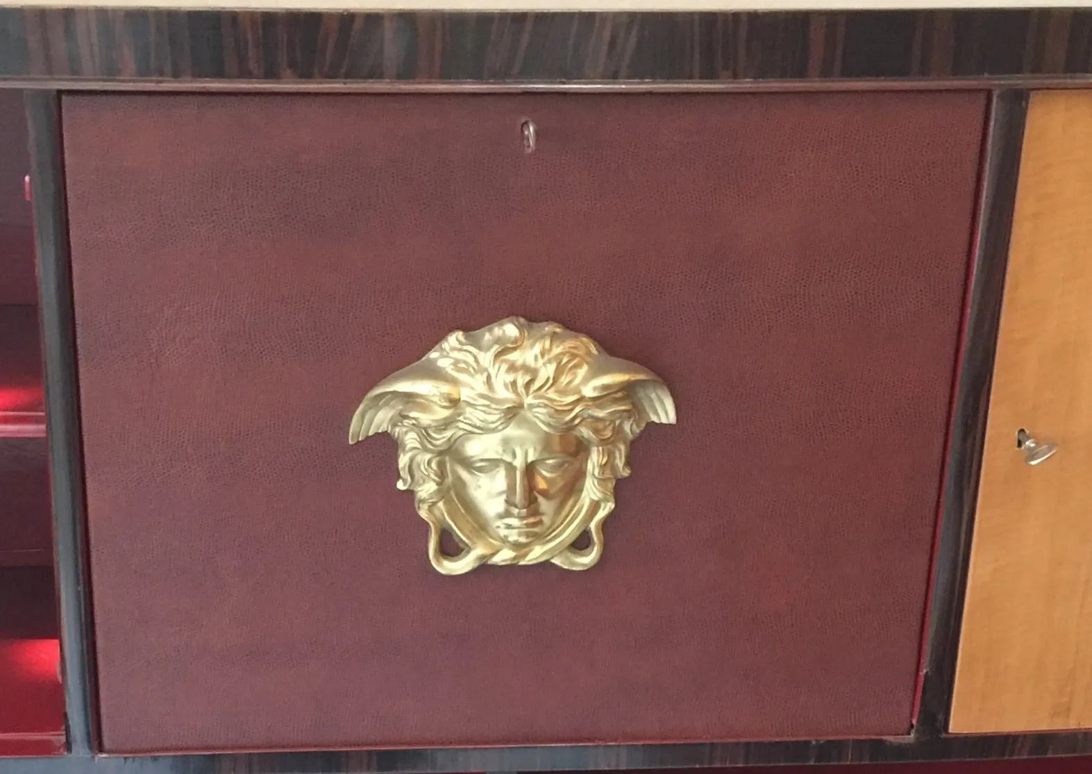 antique bookcase with golden relief details, elegant ambiance