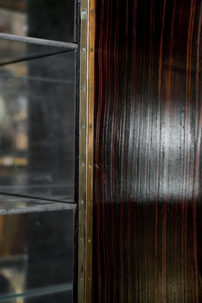 Mueble bar antiguo con acabado en madera oscura y estantes.