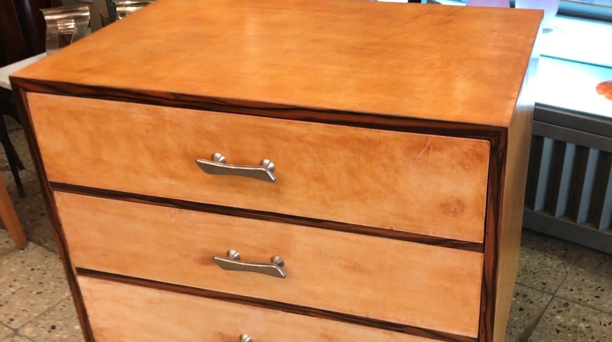 Antique bedside table with drawers and clean design, classic atmosphere.