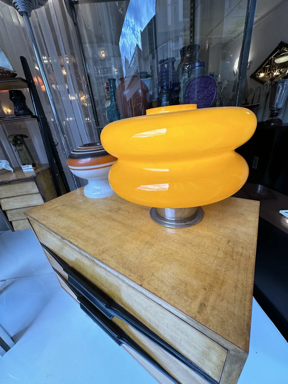 antique bedside table with yellow lamp and decorative setting