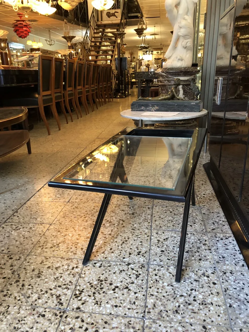 Elegant antique coffee table with glass top, decorative, in a room with other antiques