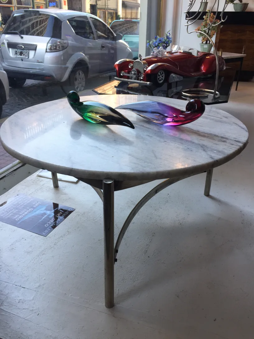 Antique coffee table art deco with colorful glass birds on top.