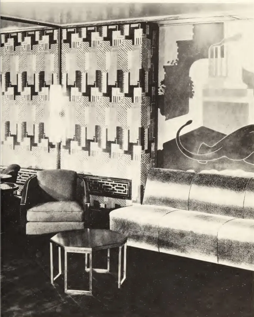 Antique coffee table by Donald Deskey in a retro setting with an armchair.