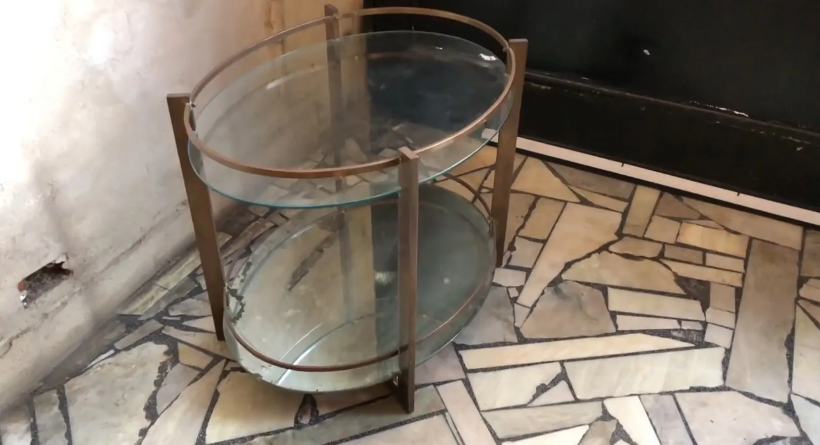 Antique bar with metal frame and two glass levels.