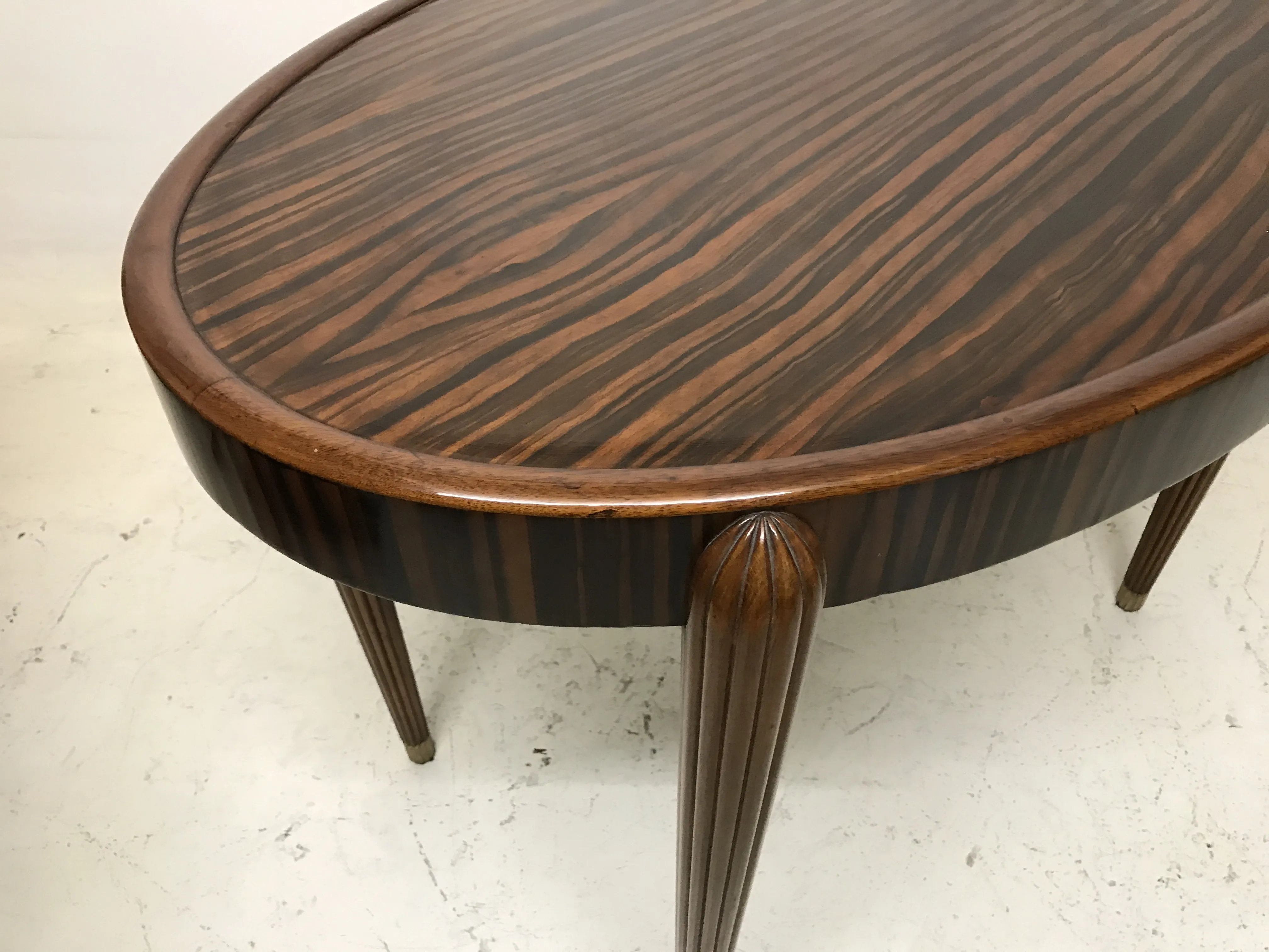 antique small round table with elegant legs in a neutral setting