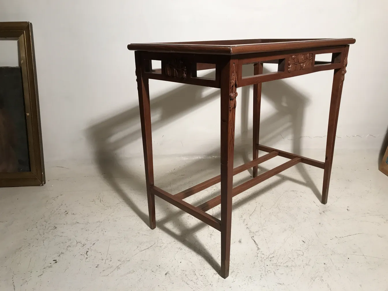 antique table in Art Nouveau style in a neutral setting