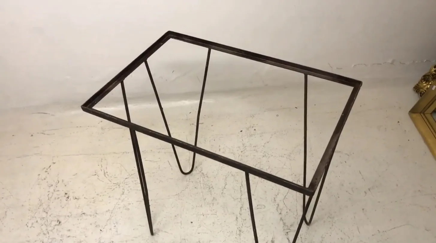 garden antique table with thin legs in a light setting