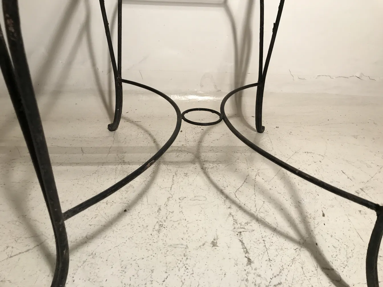 Vista de base de mesa antigua para jardín con detalles curvados