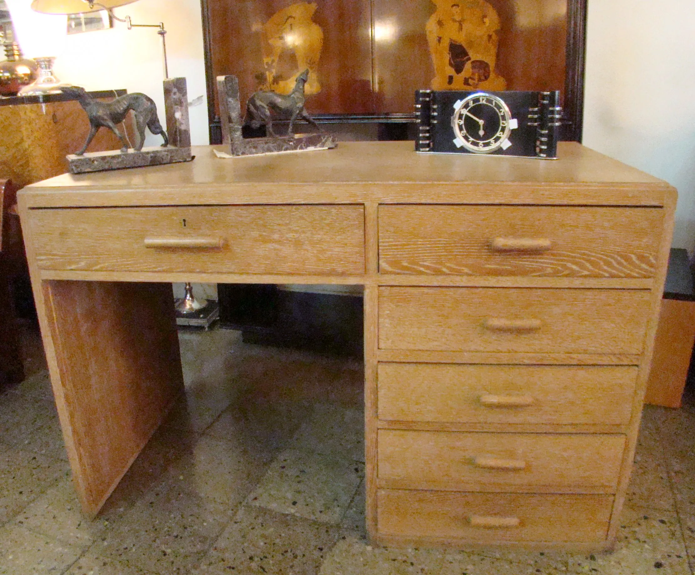 antique desk featuring multiple drawers and decorative shelves