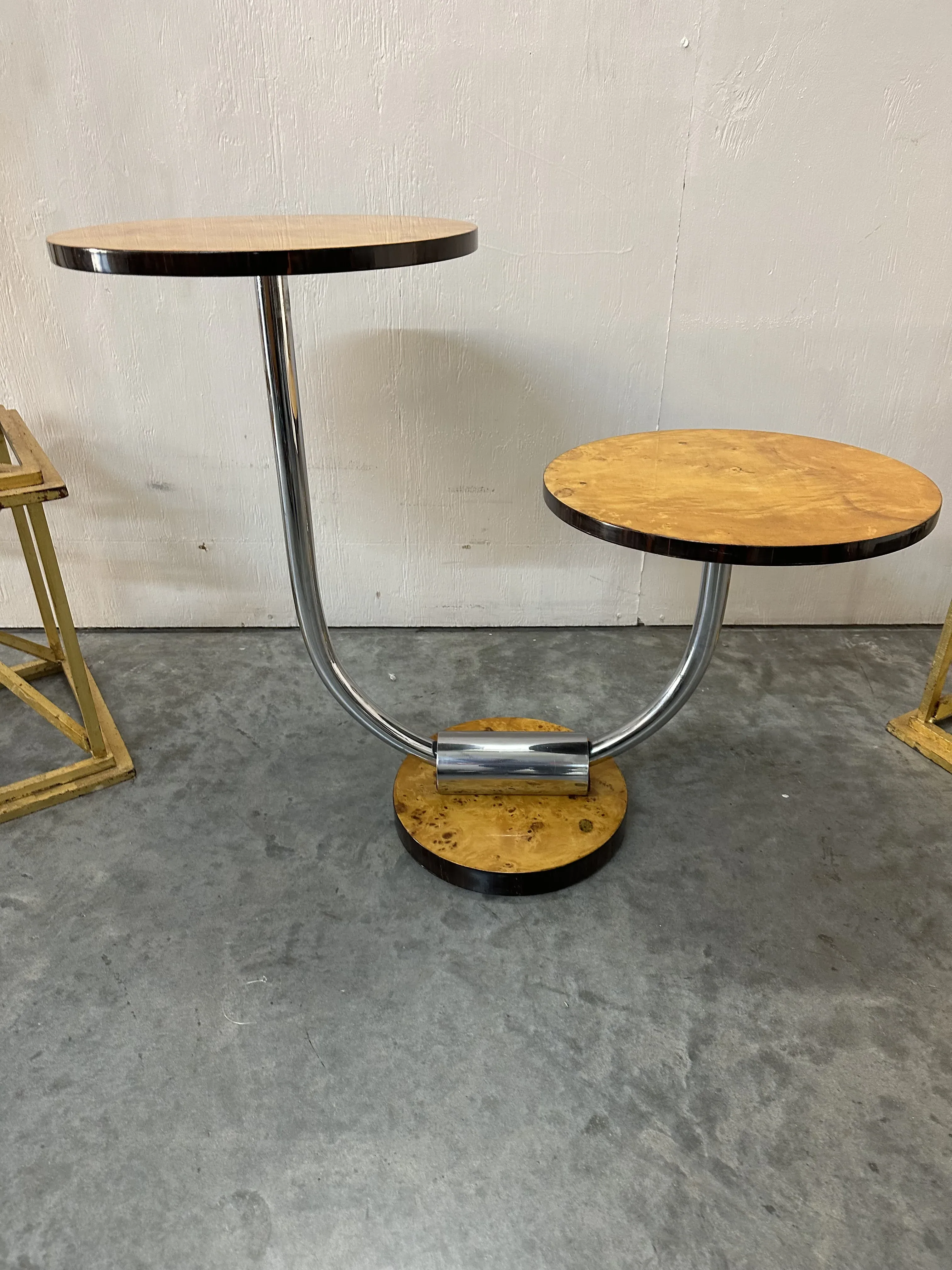 antique small table with two round tops and ring base, gray background