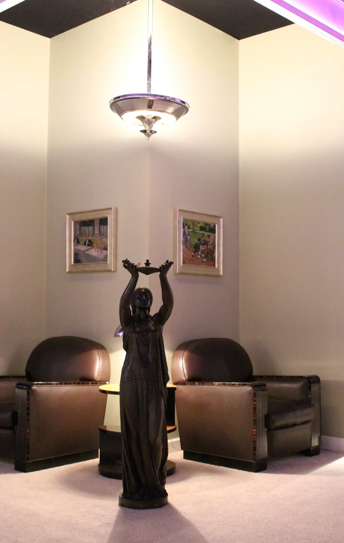 2 antique art deco hanging lamps illuminating a cozy room